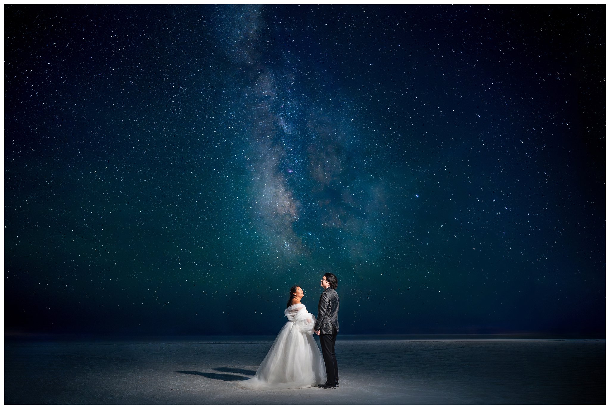 Bride and Groom share a moment together beneath the Milky Way at the Bonneville Salt Flats during inspiration elopement | Jessie and Dallin Photography