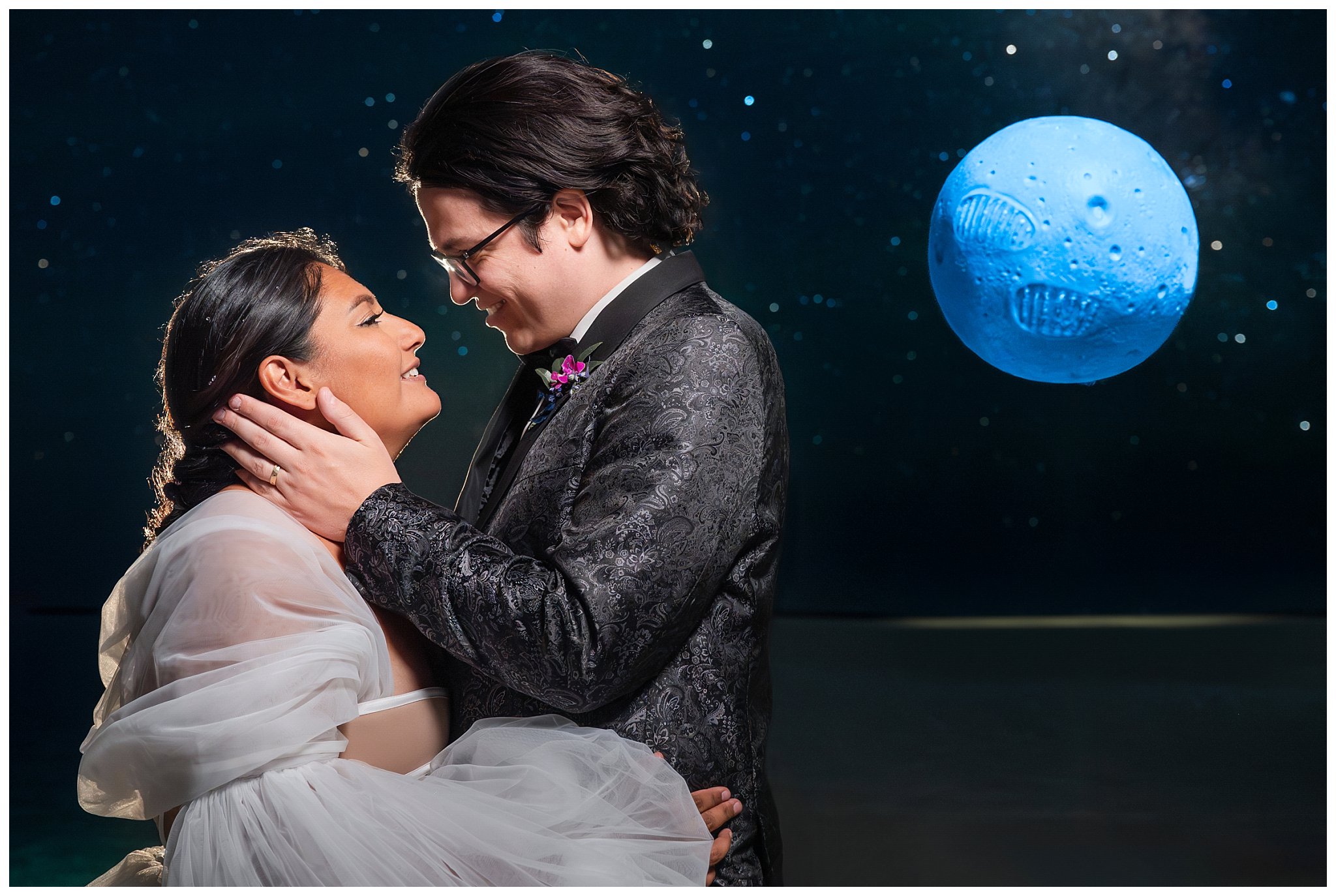 Bride and Groom share a moment beneath the stars with a floating moon landing cake that glows in the dark at the Bonneville Salt Flats during inspiration elopement | Jessie and Dallin Photography