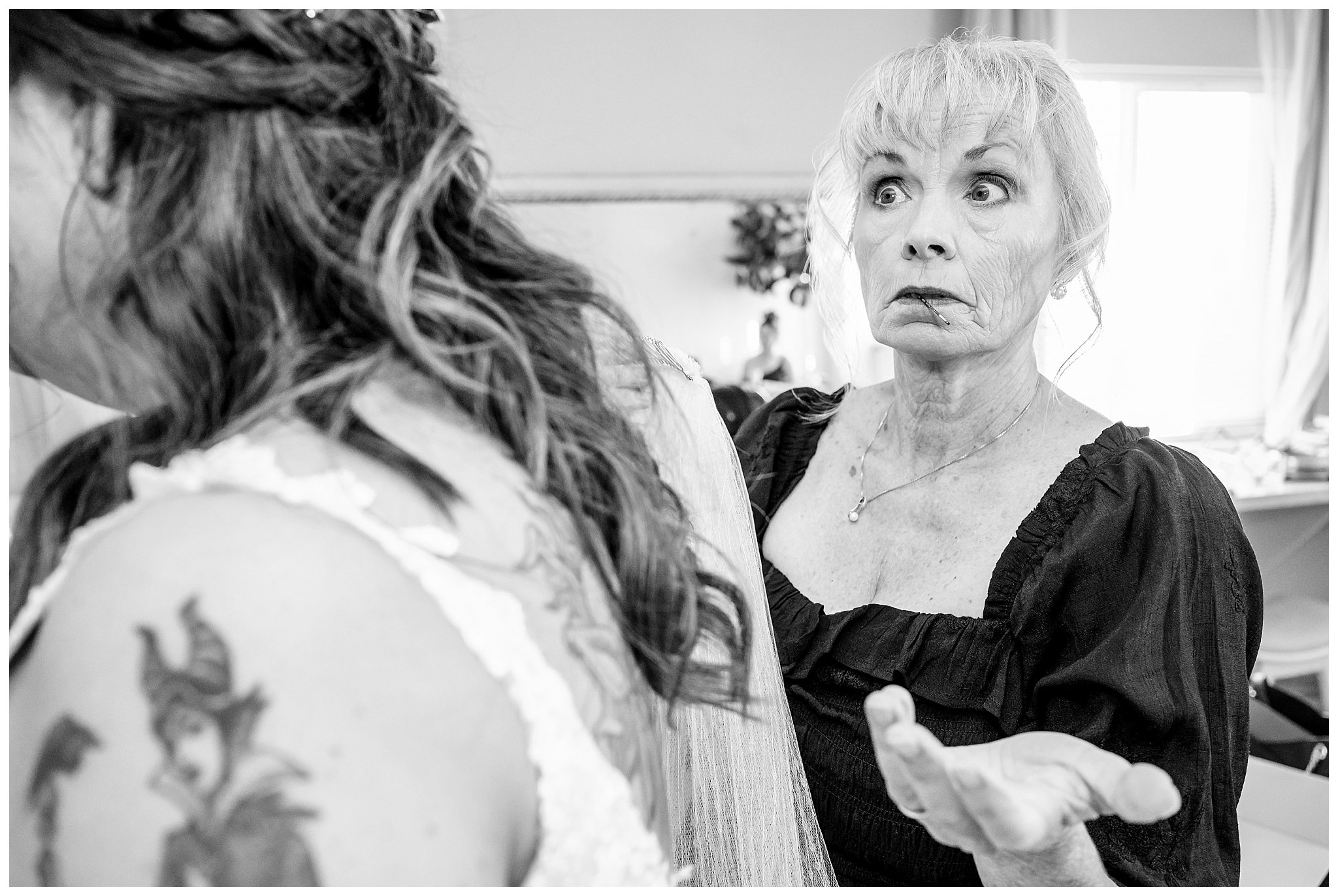 Family helps bride get into dress and mother of the bride has pins in her mouth | Star Wars Themed Wedding at Oak Hills Utah | Jessie and Dallin Photography