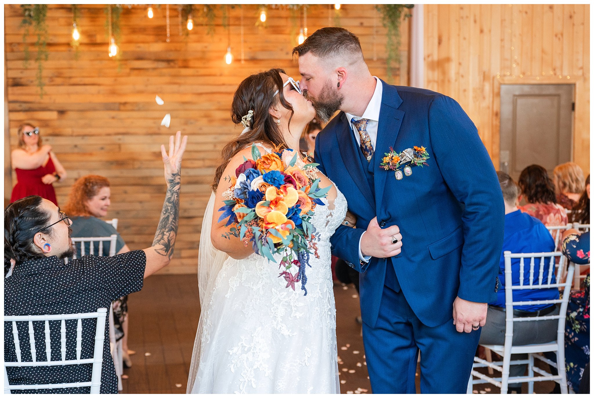 Bride and groom recessional with flower petals being tossed, and wearing sunglasses at the end of ceremony inside the barn at Oak Hills | Star Wars Themed Wedding at Oak Hills Utah | Jessie and Dallin Photography