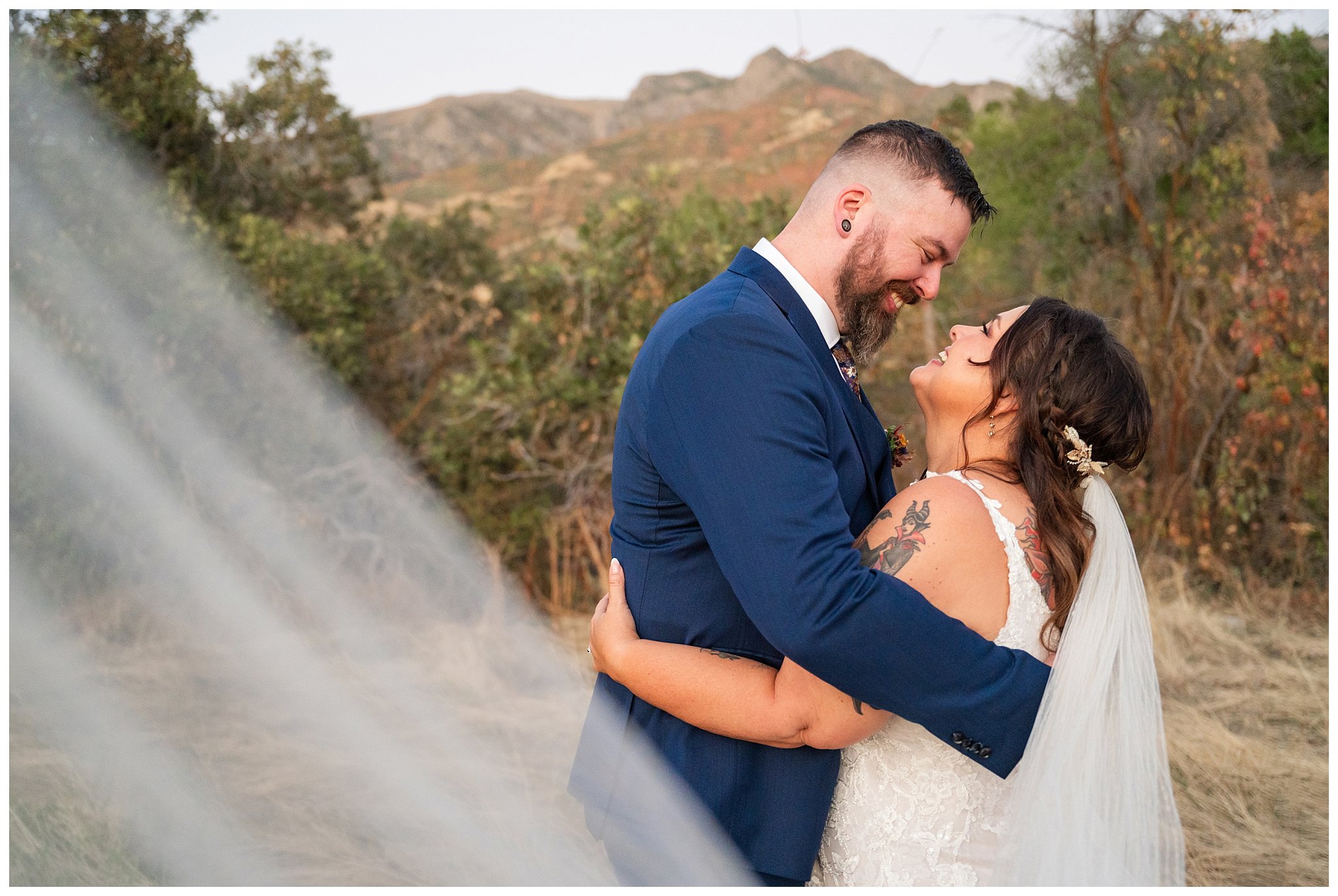 Bride and groom portraits with the mountain view at Oak HIlls at sunset. Bride in lace dress and long veil and groom in custom blue suit with Star Wars details | Star Wars Themed Wedding at Oak Hills Utah | Jessie and Dallin Photography