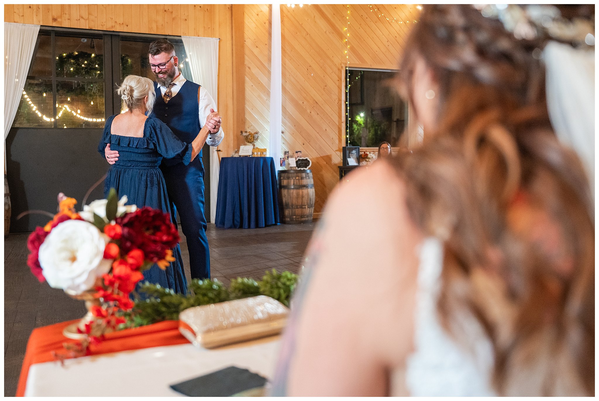 Groom shares a dance with the bride's mom, while the bride looks on in the barn at Oak Hills | Star Wars Themed Wedding at Oak Hills Utah | Jessie and Dallin Photography