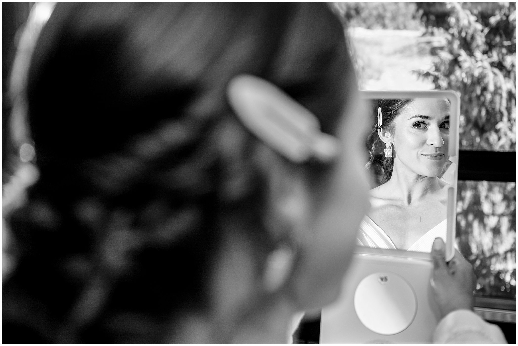 Bride looking in mirror as she gets her hair and makeup done | Snowbird Summit Summer Wedding | Jessie and Dallin Photography