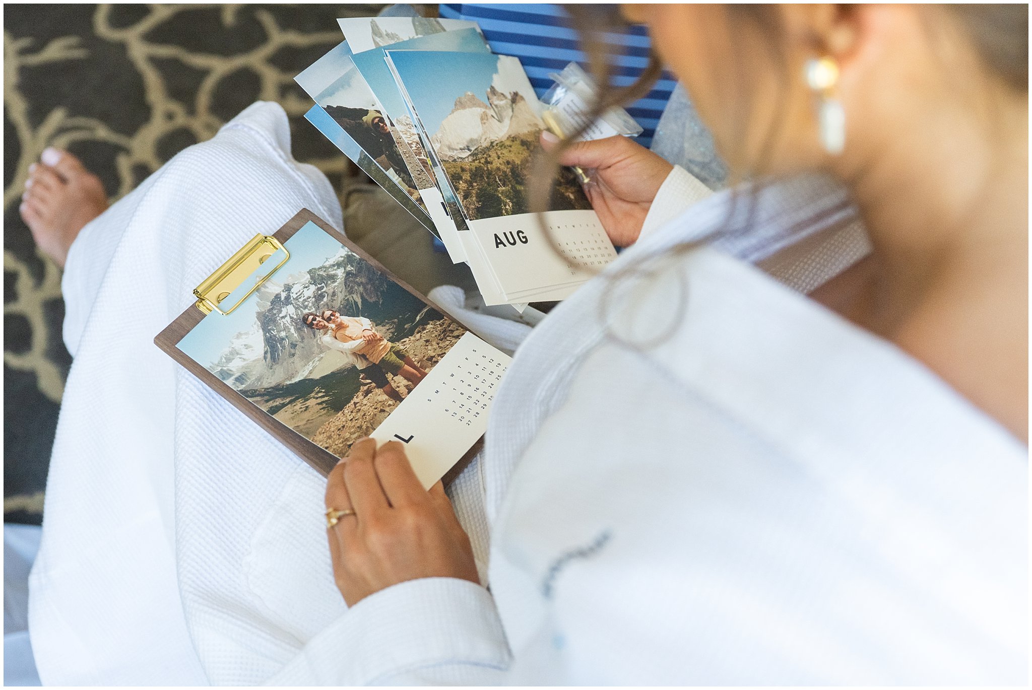 Bride looking at photo calendar gift from groom at The Cliff Lodge | Snowbird Summit Summer Wedding | Jessie and Dallin Photography