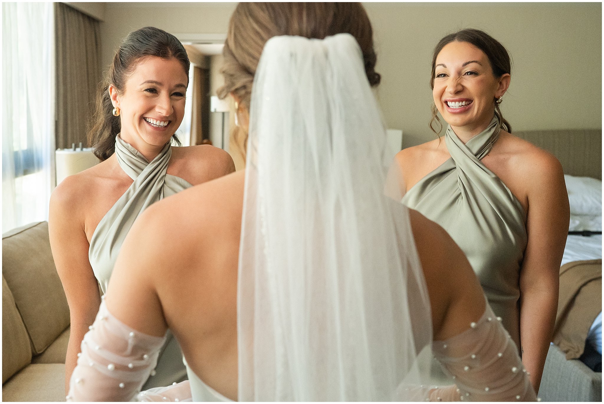 Bride and bridesmaids in sage green dresses sharing a first look at The Cliff Lodge | Snowbird Summit Summer Wedding | Jessie and Dallin Photography