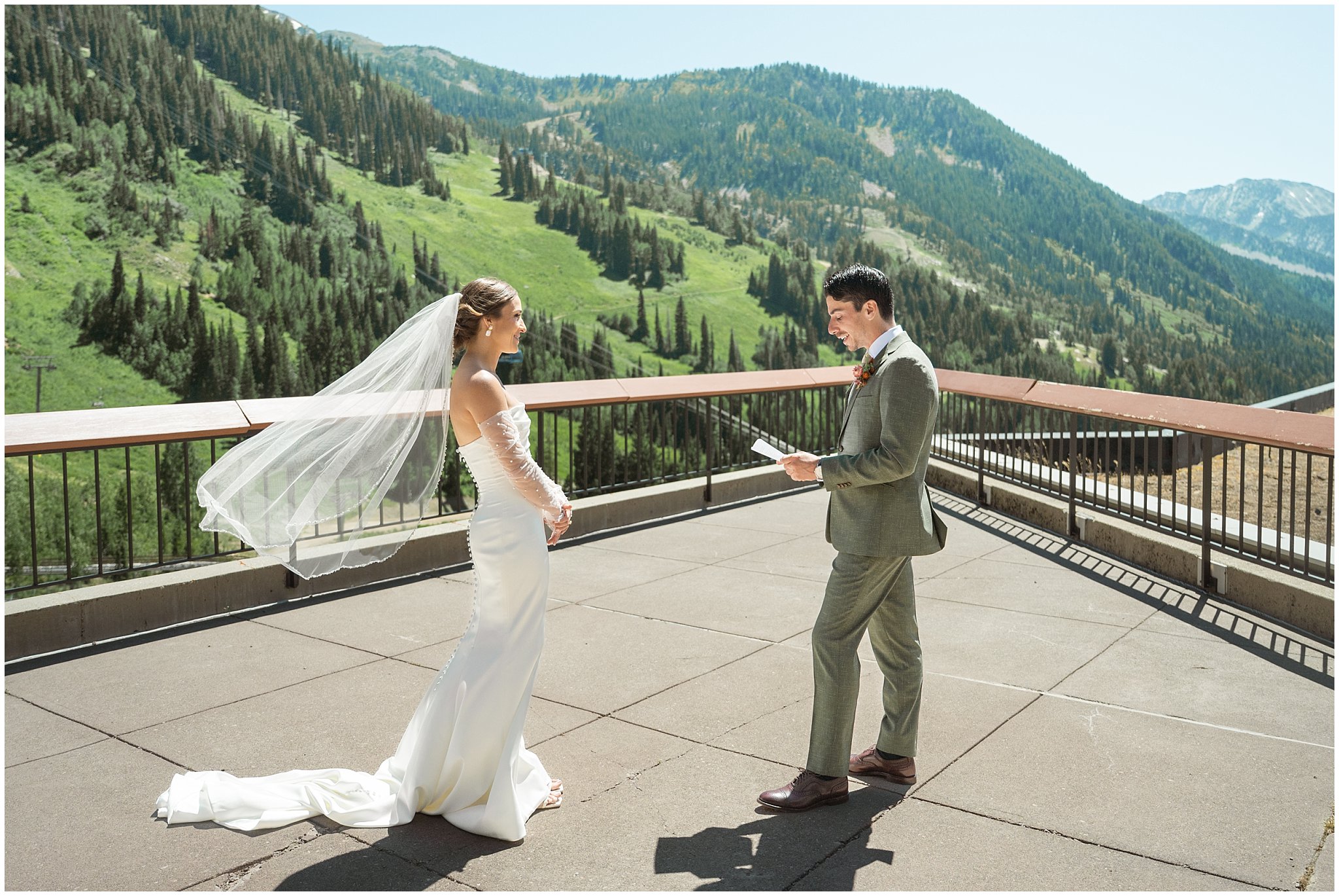 Bride and groom sharing a first look on the rooftop of The Cliff Lodge. Groom wearing a sage green suit and golden tie, bride in a strapless dress with gloves and veil | Snowbird Summit Summer Wedding | Jessie and Dallin Photography
