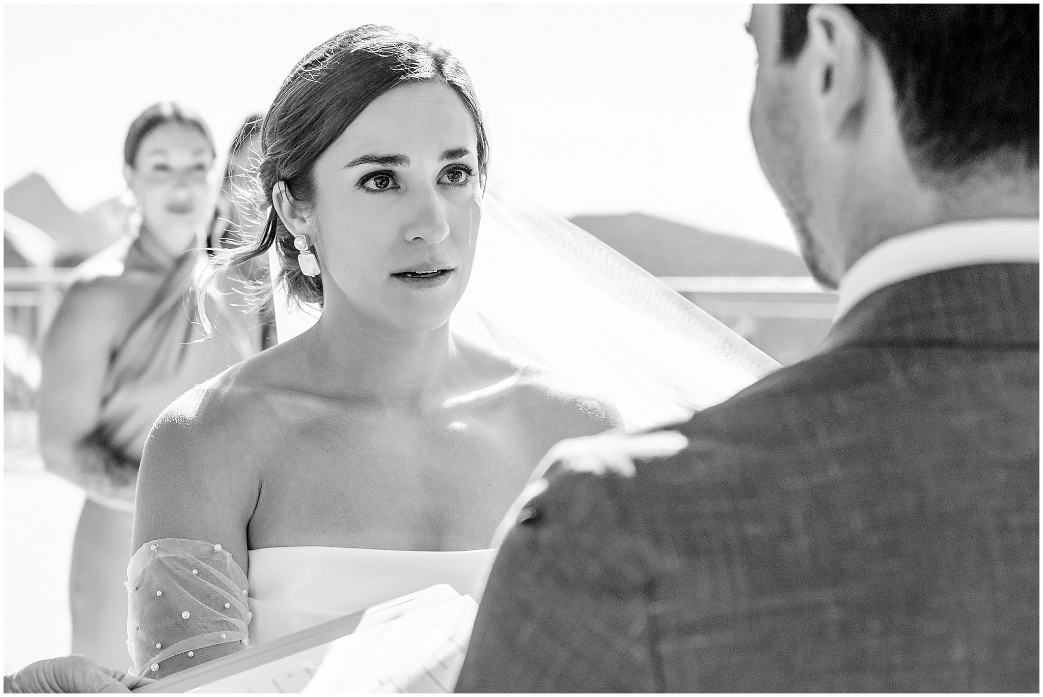 Bride crying at the top of the aisle during ceremony. Groom wearing a sage green suit and golden tie, bride in a strapless dress with gloves and veil | Snowbird Summit Summer Wedding | Jessie and Dallin Photography