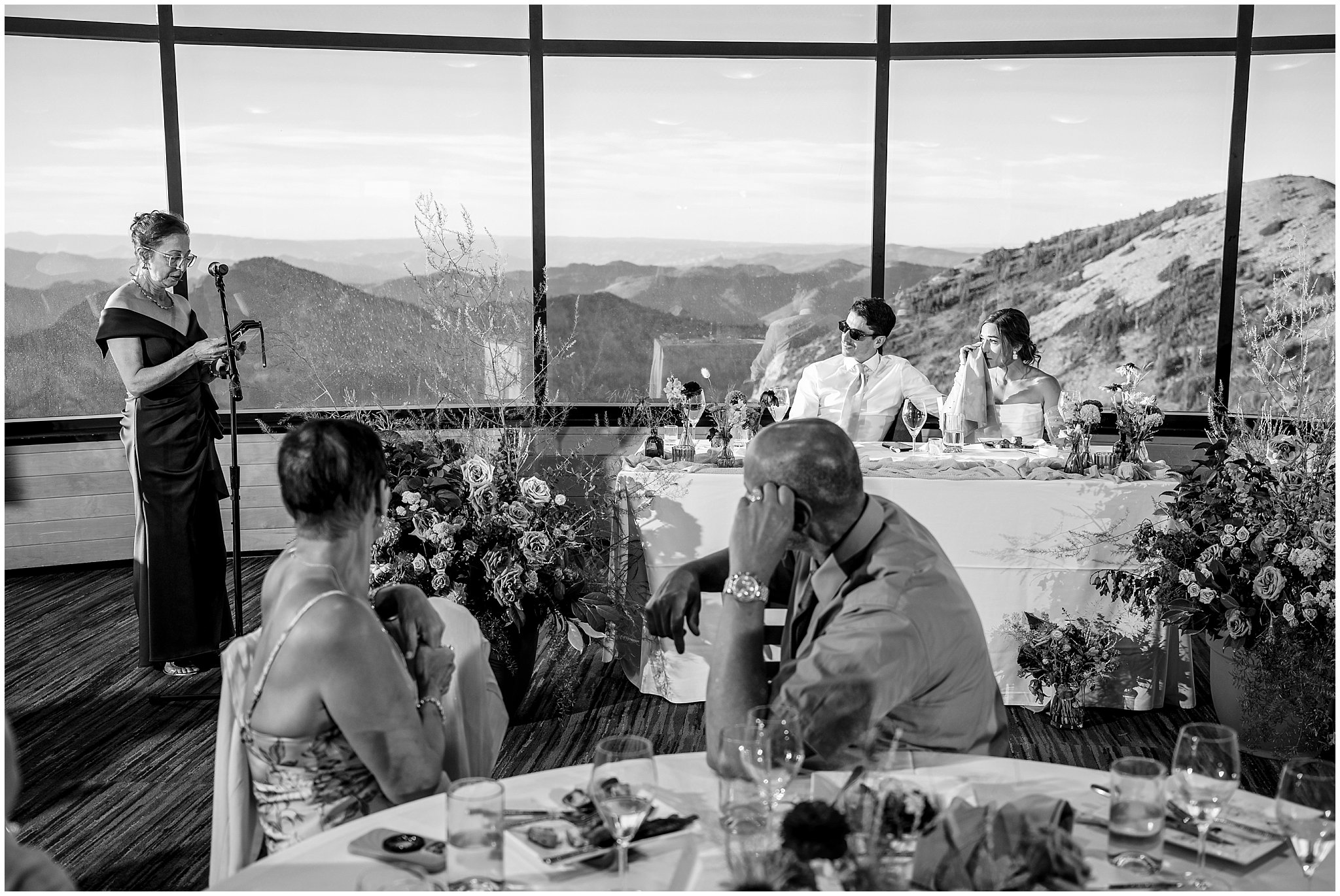 Bride and groom get emotional during toasts and speeches at dinner. Groom wearing a sage green suit and golden tie, bride in a strapless dress with gloves and veil | Snowbird Summit Summer Wedding | Jessie and Dallin Photography