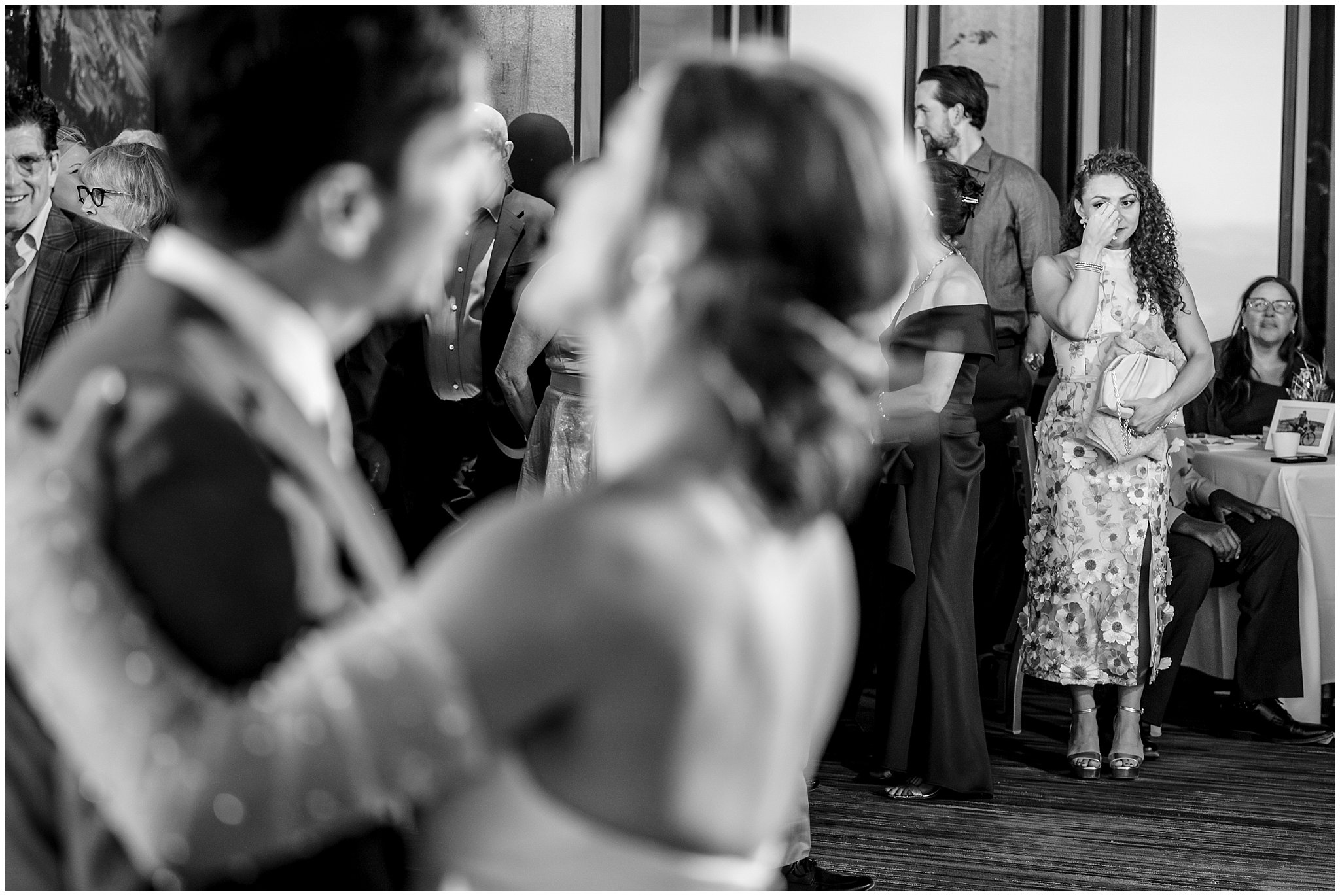 Family member crying in the background as bride and groom share an emotional first dance inside the lodge | Snowbird Summit Summer Wedding | Jessie and Dallin Photography