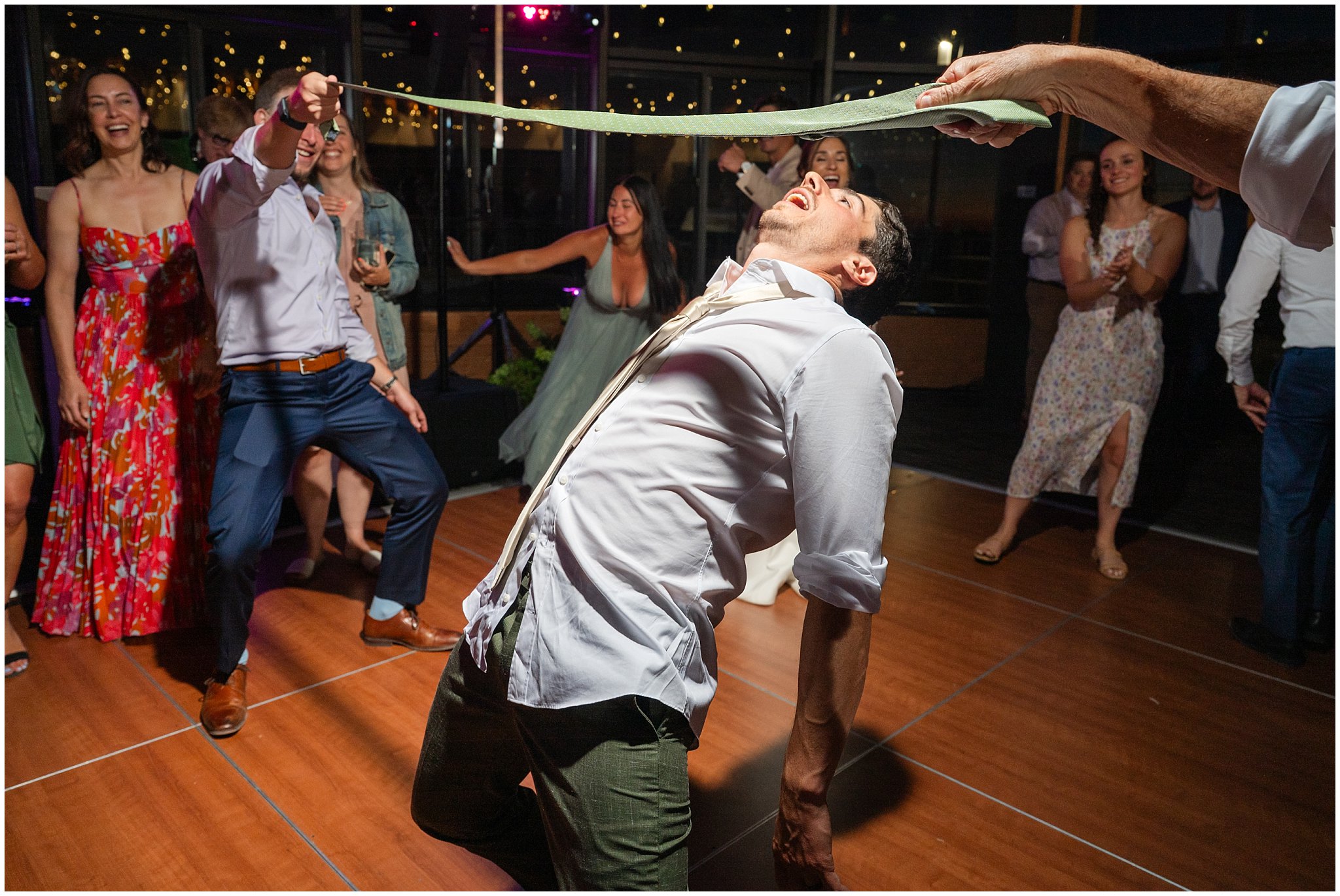 Doing limbo dancing during reception party dancing inside the lodge | Snowbird Summit Summer Wedding | Jessie and Dallin Photography
