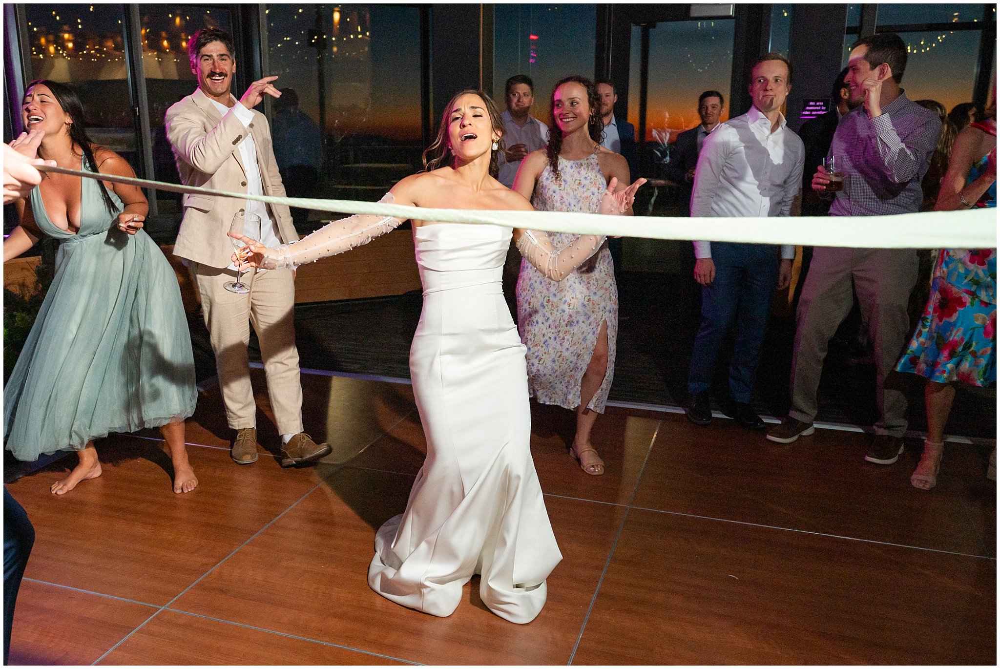 Doing limbo dancing during reception party dancing inside the lodge | Snowbird Summit Summer Wedding | Jessie and Dallin Photography