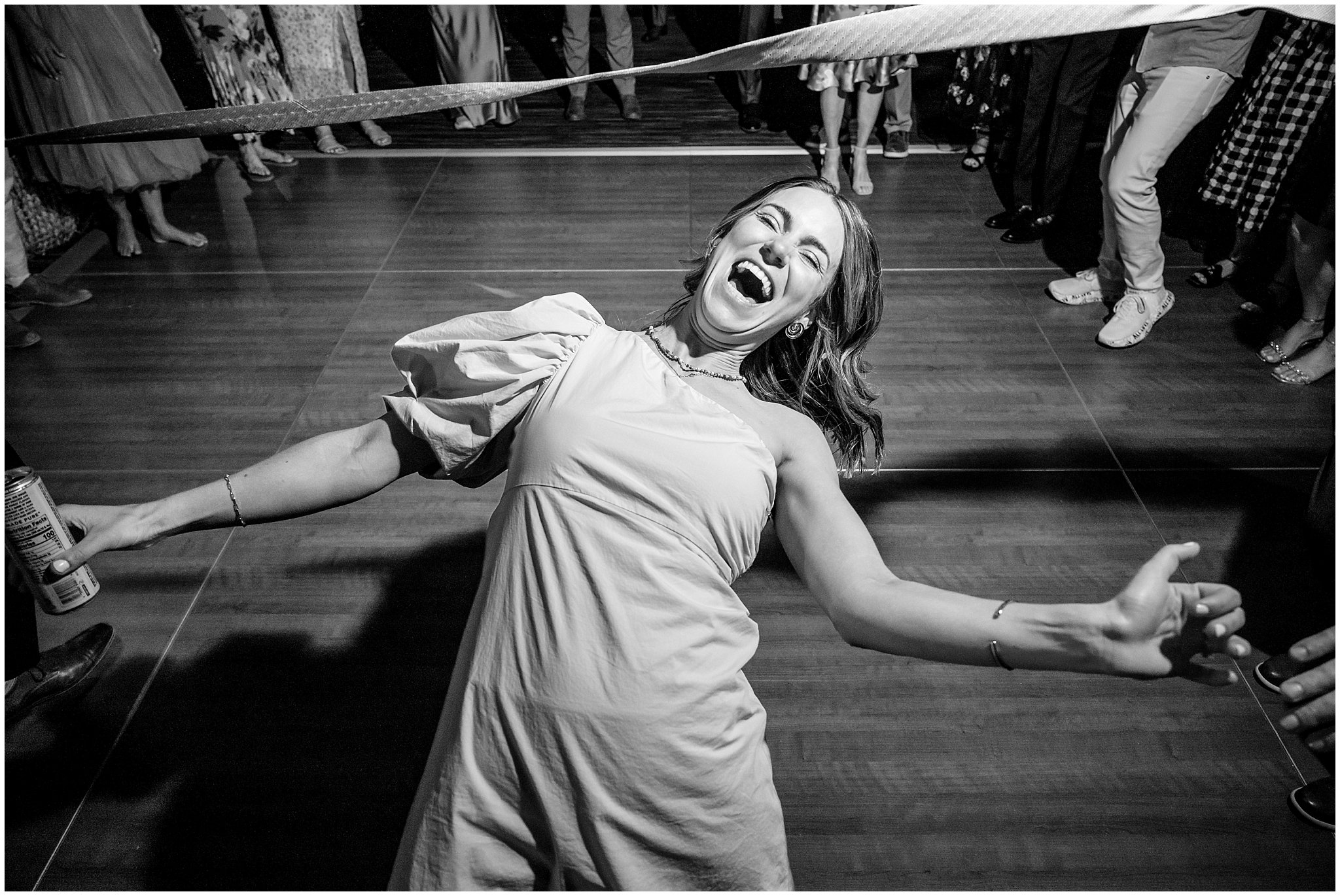 Doing limbo dancing during reception party dancing inside the lodge | Snowbird Summit Summer Wedding | Jessie and Dallin Photography