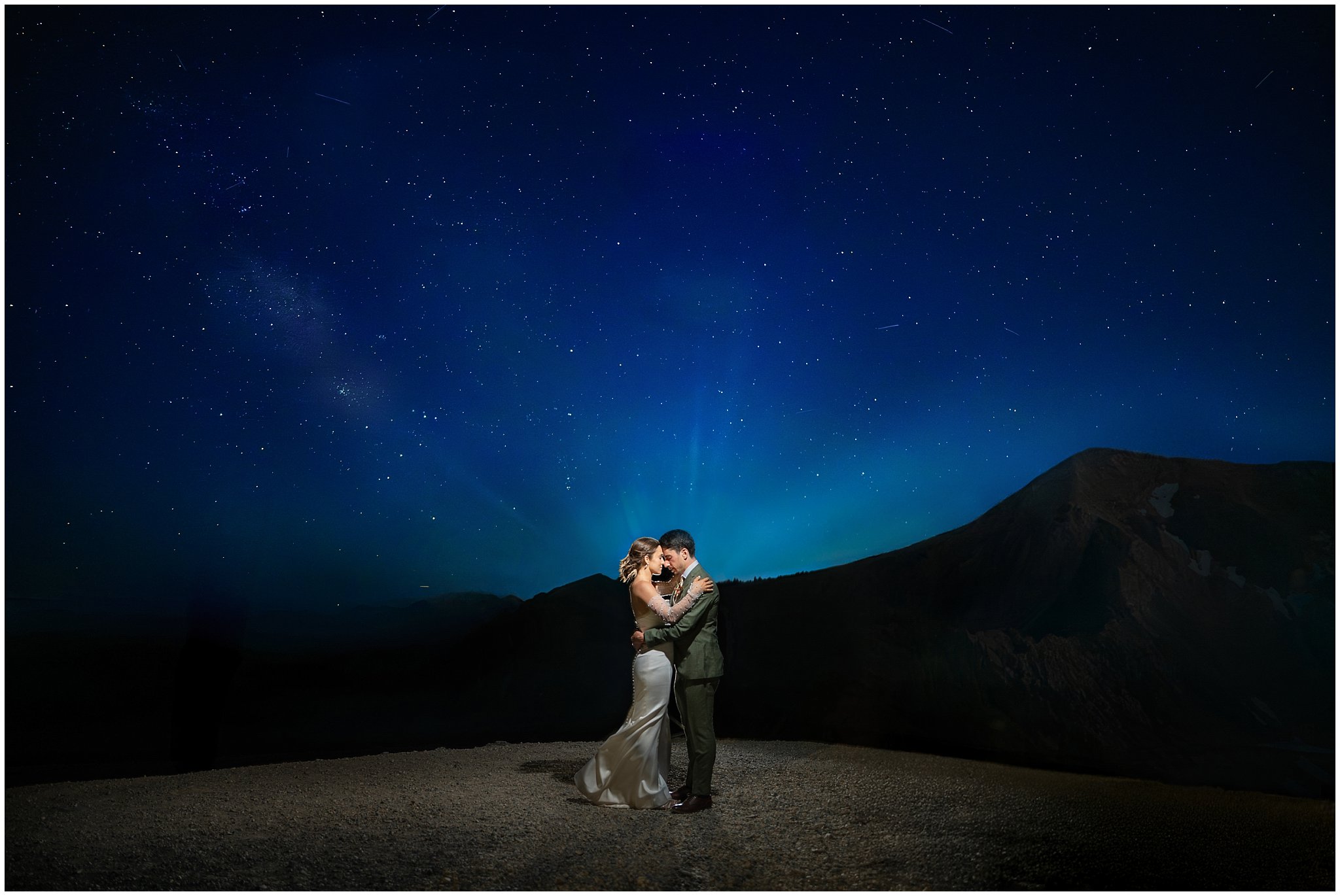Bride and groom beneath the stars at night surrounded by mountains on top of Snowbird | Snowbird Summit Summer Wedding | Jessie and Dallin Photography